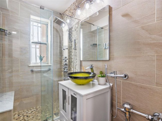 Bathroom with a stall shower and vanity | Image 12