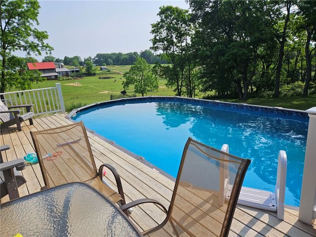 Covered rear deck to the above ground pool | Image 23