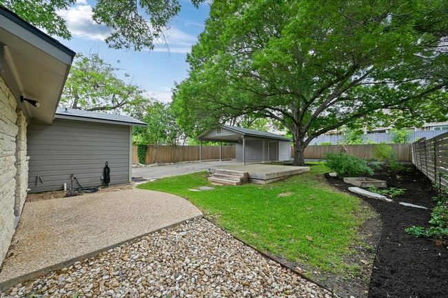 Fenced backyard with a patio | Image 23