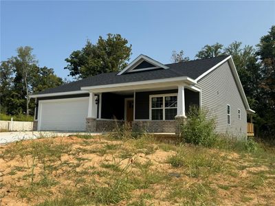 Craftsman-style home featuring a garage and a front lawn | Image 2