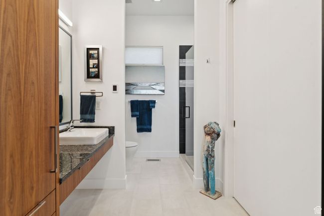 Full bath featuring vanity, a stall shower, and tile patterned flooring | Image 34