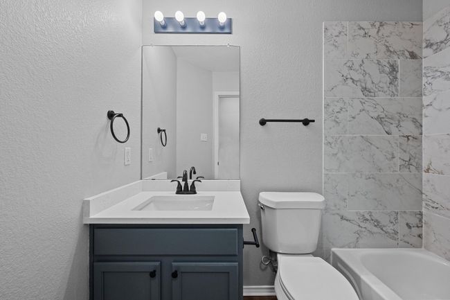 Bathroom featuring new vanity, bathtub/shower combination | Image 19
