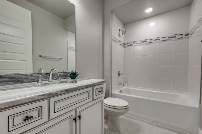 Full bathroom featuring vanity, Dolomite counters, shower-over-tub and tile floors | Image 16