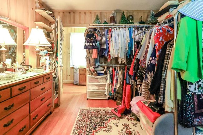Walk in closet with light wood finished floors | Image 13