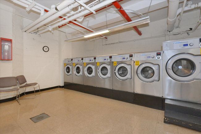 Shared laundry room with washer and clothes dryer and tile patterned floors | Image 21