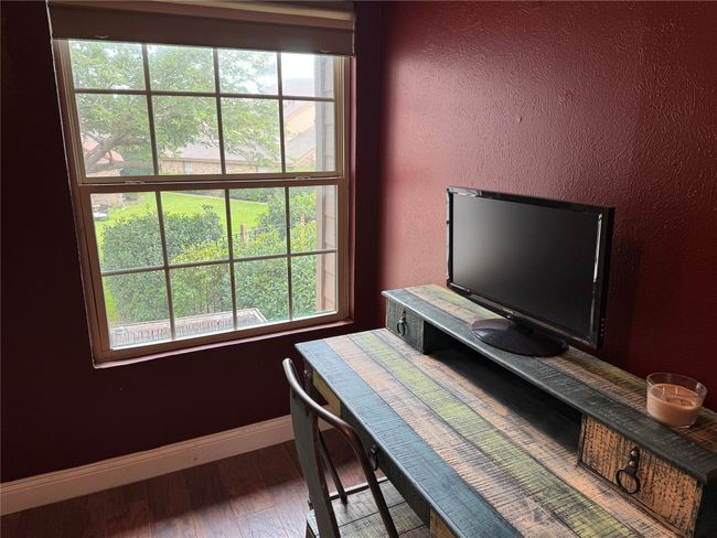 Office space featuring wood finished floors and a textured wall | Image 9