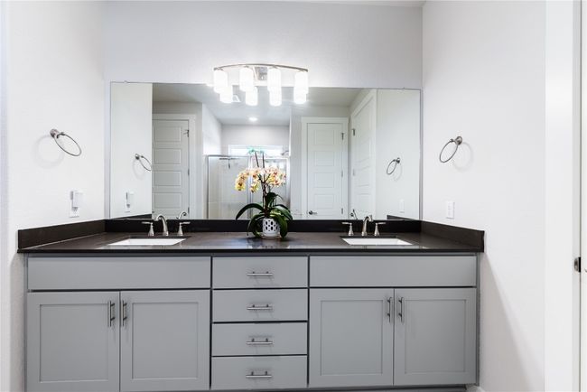 Full bath featuring double vanity, a sink, and a stall shower | Image 18