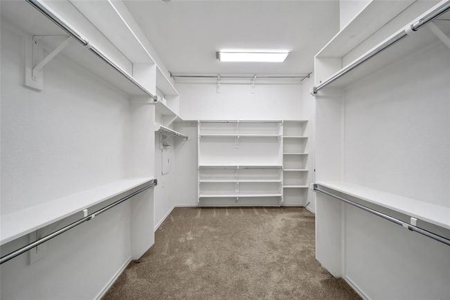 Massive walk-in closet for the primary bedroom that connects directly to the laundry room. | Image 23