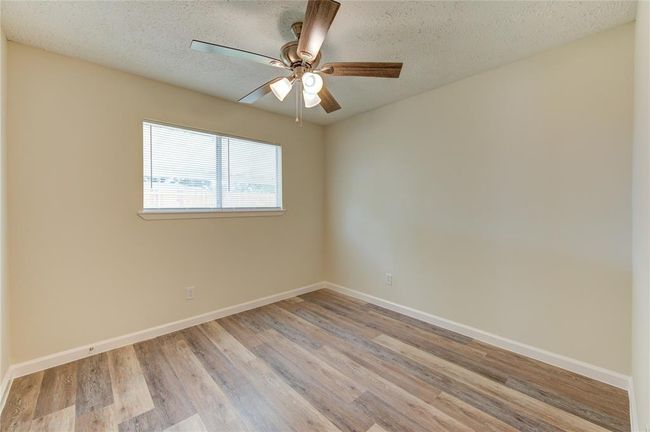 Bedroom 2. All bedrooms have blinds and new ceiling fans | Image 13