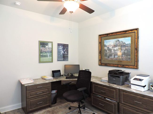 Office area with wood finished floors, ceiling fan, and baseboards | Image 26
