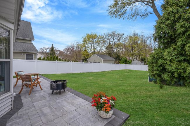 View of yard with an outdoor fire pit, fence private yard, and a patio | Image 9