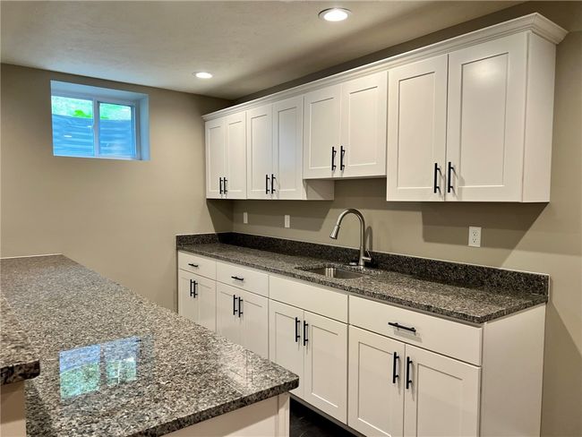 Fantastic social center in the lower level with sink, granite tops | Image 22