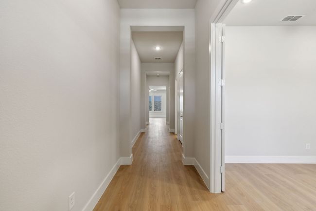 Corridor featuring light wood-style floors and baseboards | Image 9