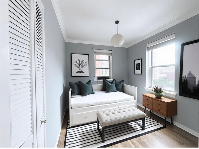 Bedroom with crown molding and wood finished floors | Image 10