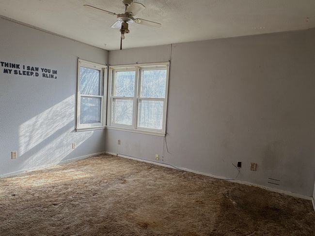 Empty room with carpet flooring and ceiling fan | Image 10
