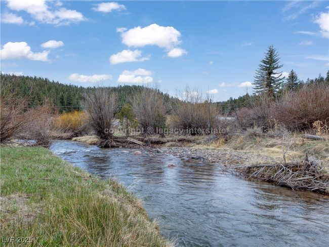 Property view of water featuring a wooded view | Image 44