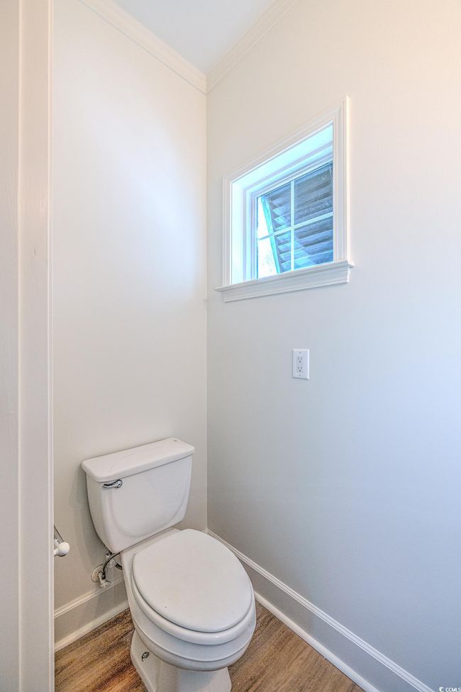 Bathroom with wood finished floors and crown molding | Image 21