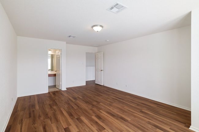 Unfurnished bedroom with dark wood-type flooring, visible vents, and baseboards | Image 22