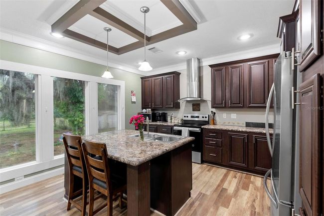 Pendant lights over island with kitchen sink and dishwasher | Image 10