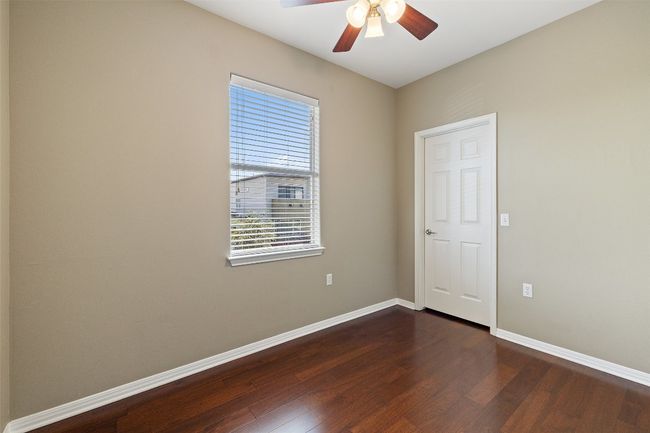 Unfurnished room featuring dark wood-style flooring, a ceiling fan, and baseboards | Image 30