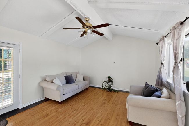 Living room featuring light wood-style floors and a ceiling fan | Image 25