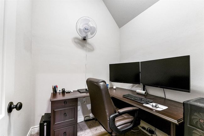 The office space with a door offers plenty of room for creating an ideal home office. This private area provides ample space for a desk, shelving, and any other office essentials, offering a quiet and functional environment for work or study. With the option to close the door, it also ensures added privacy and a dedicated workspace within the home. | Image 30
