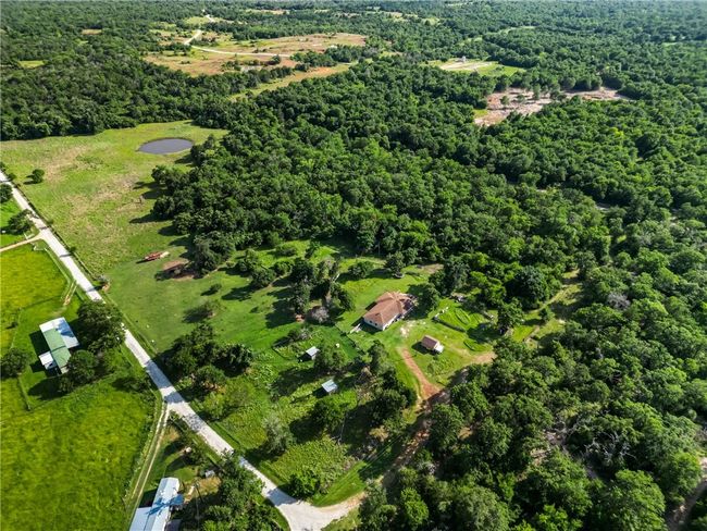 Aerial view of property and surrounding area featuring a heavily wooded area | Image 40