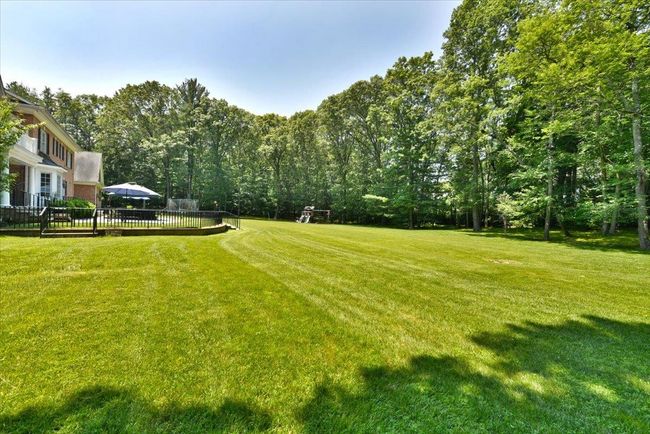 View of green lawn featuring a wooden deck | Image 34