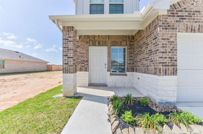 Covered front porch with beautiful stone and brick elevation. | Image 7