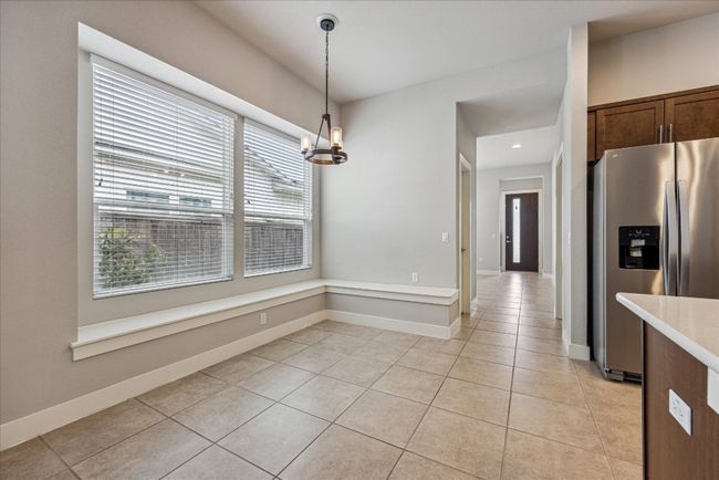 Unfurnished dining area with light tile patterned floors, a chandelier, baseboards, and recessed lighting | Image 11