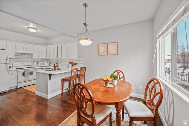 Dining space featuring dark hardwood / wood-style flooring and sink | Image 9