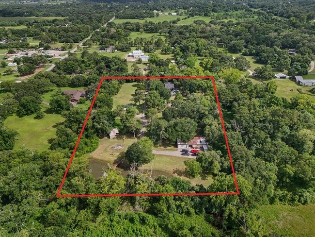 Aerial view from the rear showing the pond, barn, and lush acreage. | Image 14