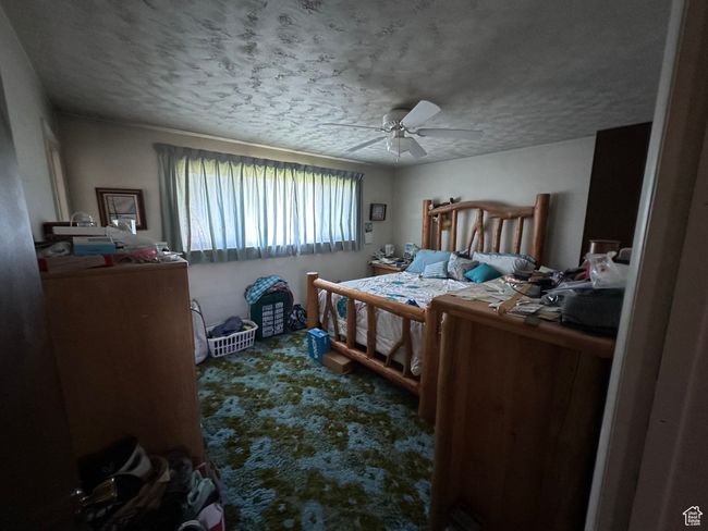 Carpeted bedroom featuring a textured ceiling and a ceiling fan | Image 11