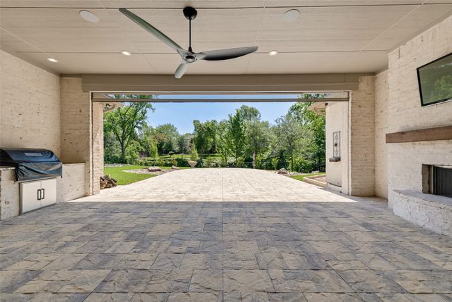View of patio / terrace with a ceiling fan, area for grilling, and decorative driveway | Image 36