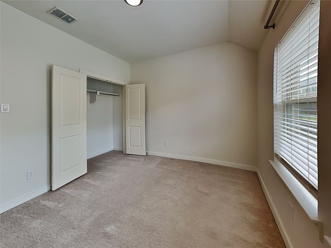 Unfurnished bedroom featuring carpet, lofted ceiling, a closet, and baseboards | Image 8