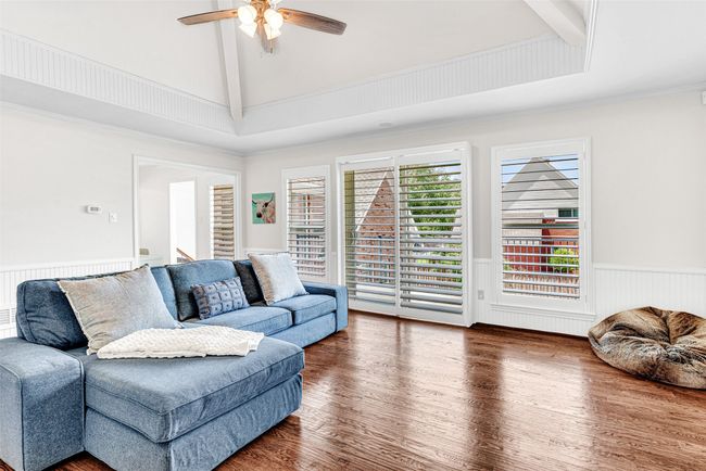 Upstairs is a cozy game room, also with wood floors and a sunny balcony overlooking the pool below. Space for some comfy chairs and bistro table to enjoy the sunshine! | Image 13