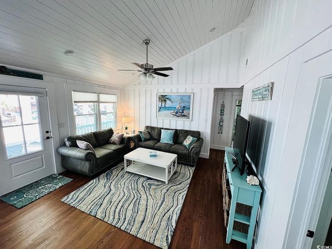 Living room with ceiling fan, lofted ceiling, dark hardwood / wood-style floors, and wooden ceiling | Image 11