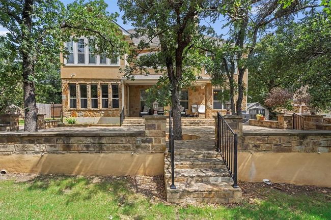 Rear view of house featuring stucco siding and stone siding | Image 35