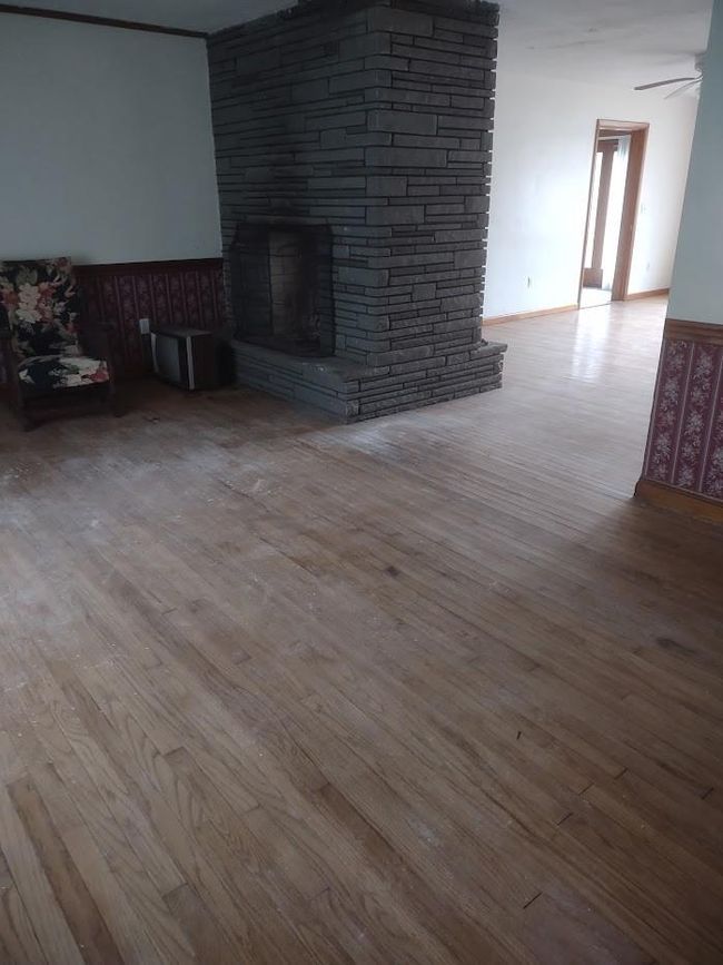 Unfurnished living room featuring ceiling fan, a fireplace, and hardwood / wood-style flooring | Image 6