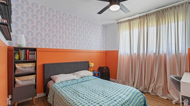 Bedroom featuring wood finished floors and ceiling fan | Image 10