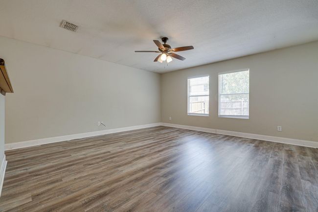 Empty room featuring a ceiling fan and wood finished floors | Image 14