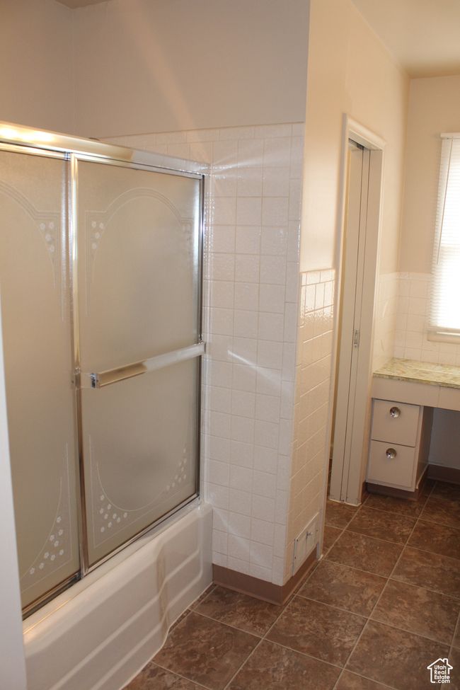 Bathroom featuring shower / bath combination with glass door and vanity | Image 12