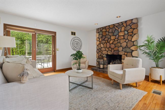 Cozy up to the gas log stone fireplace | Image 17