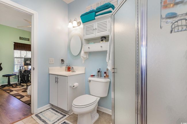 Bathroom featuring tile patterned flooring, toilet, vanity, and baseboards | Image 18