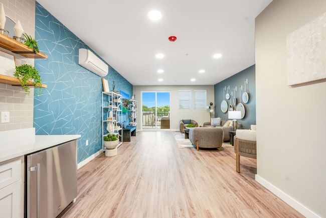 Sitting room featuring a wall mounted air conditioner, baseboards, light wood-style flooring, and recessed lighting | Image 26
