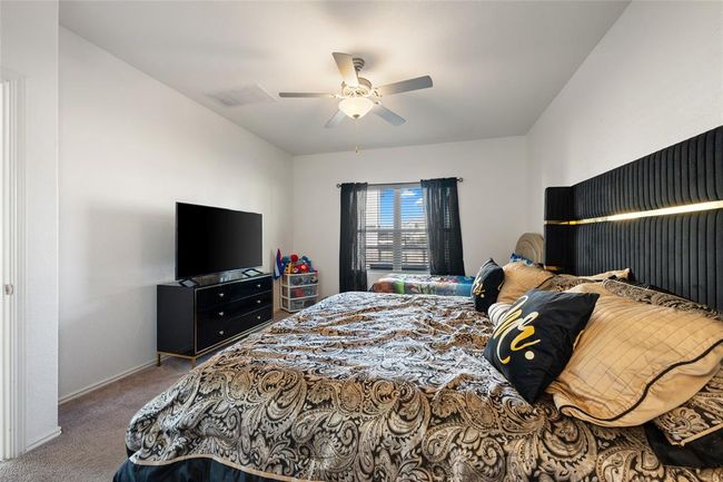 Carpeted bedroom with ceiling fan and baseboards | Image 15