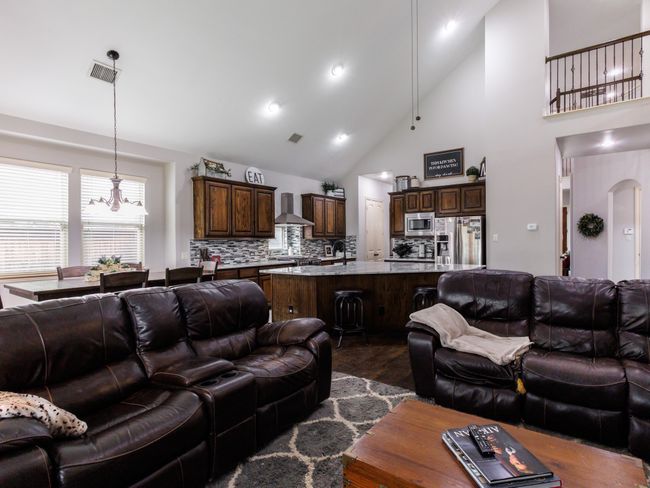 This angle showcases the soaring high vaulted ceilings and open layout of the main level. | Image 4