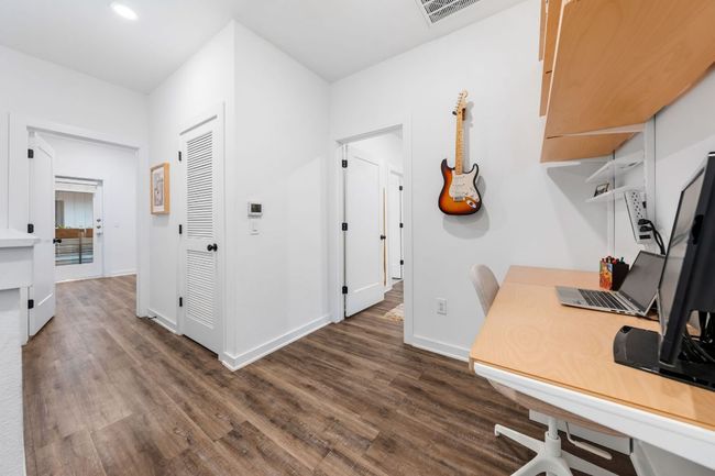 Office space featuring dark wood-type flooring, baseboards, and visible vents | Image 18