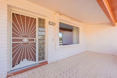 Expanded covered north-facing front patio with security screen door. | Image 3