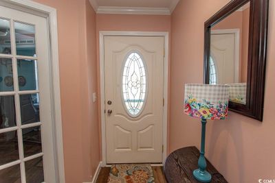 Doorway to outside with ornamental molding | Image 3